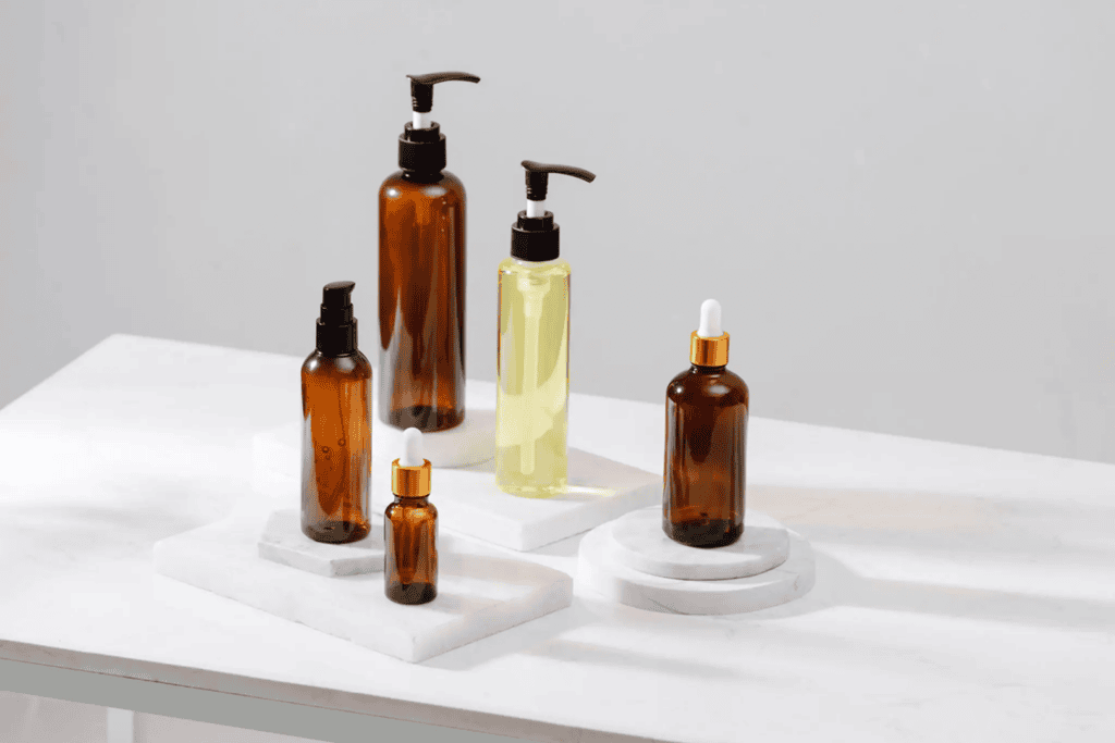 Brown and clear bottles on white surface.