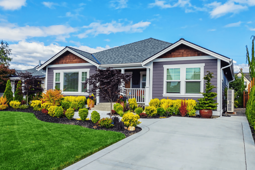Suburban house with manicured lawn and garden.